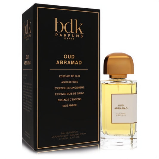 Elegant Bdk Oud Abramad 3.4 oz unisex Eau de Parfum bottle with luxurious gold cap, displayed with its sleek black and gold box.