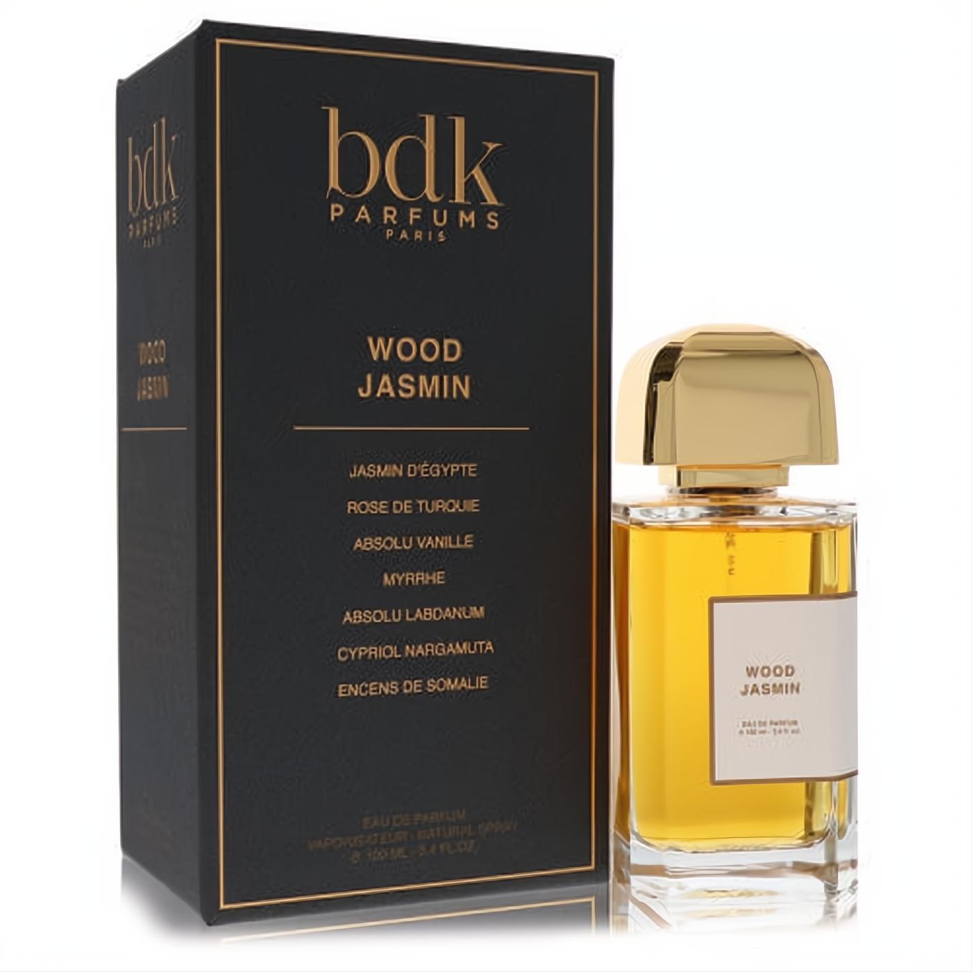 Luxurious Bdk Wood Jasmin Eau De Parfum spray, 3.4 oz, in a clear bottle with gold cap, beside its elegant black and gold box.