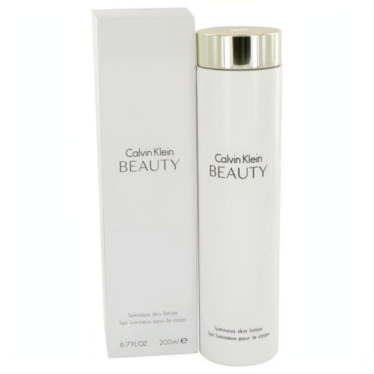 Indulge in Calvin Klein Beauty 6.7 oz luminous body lotion. Sleek white bottle, elegant metallic cap, and matching box.