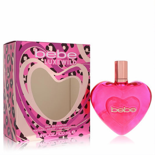 Bebe Luxe Wild 3.4 oz women's EDP. Vibrant pink heart bottle with sparkling gold "bebe" logo, beside a chic leopard print box.