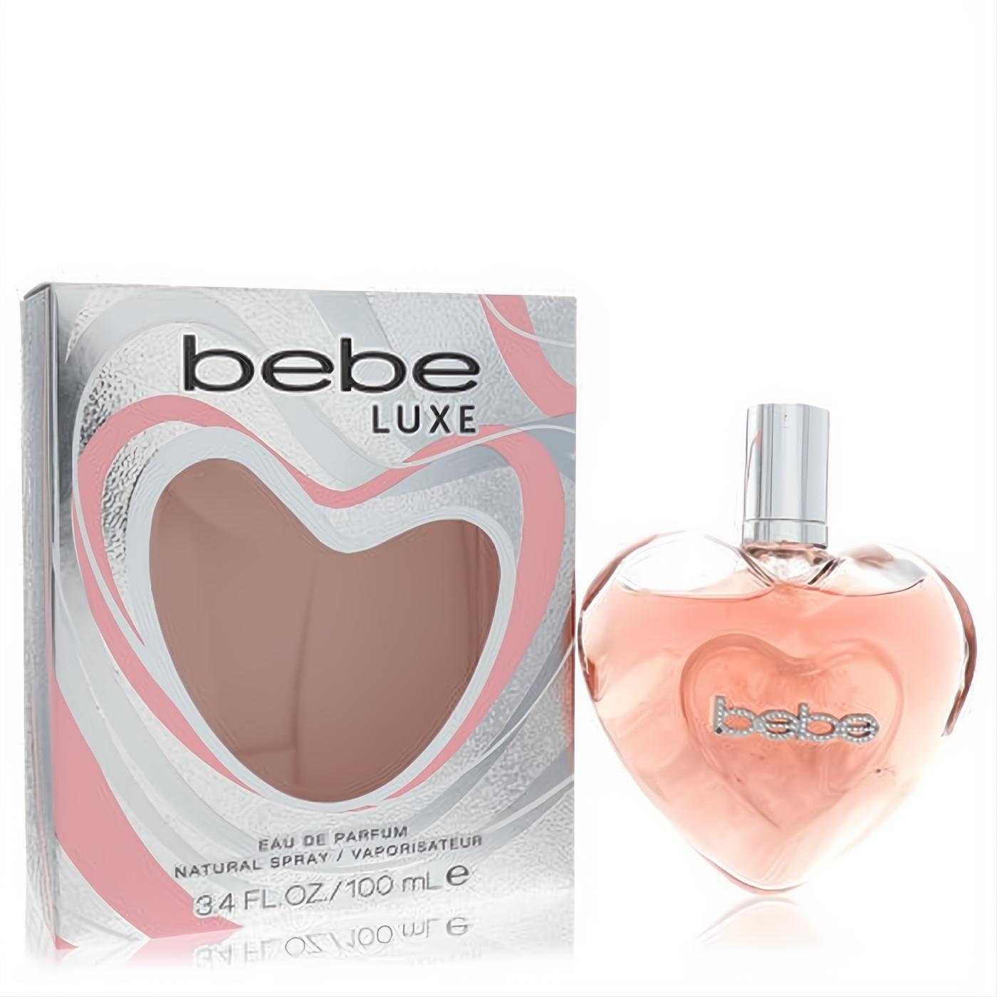 Captivating Bebe Luxe women's Eau de Parfum. Heart-shaped glass bottle with pink liquid, silver cap, and stylish silver/pink box. 3.4 oz.