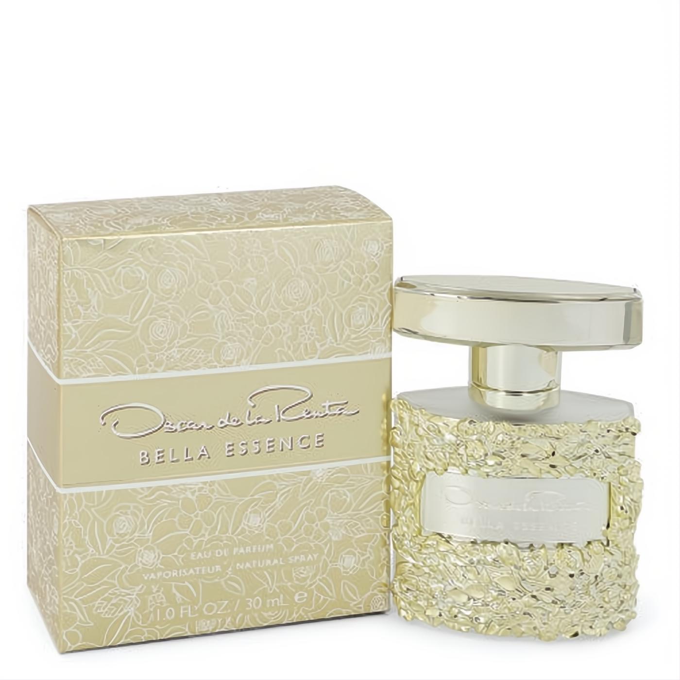 Elegant Oscar De La Renta Bella Essence 1 oz EDP in a stunning gold floral embossed bottle, next to its matching luxurious box.