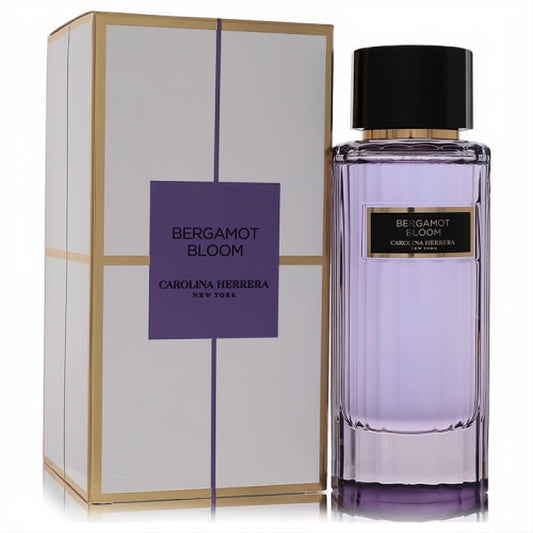 Elegant Carolina Herrera Bergamot Bloom 3.4oz EDT. Lavender liquid in a ribbed glass bottle with gold accents, next to its white and gold box.