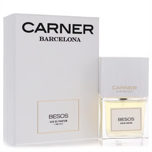 Carner Barcelona Besos Eau De Parfum. Clear glass bottle with light yellow liquid, elegant white cap, and matching white box.
