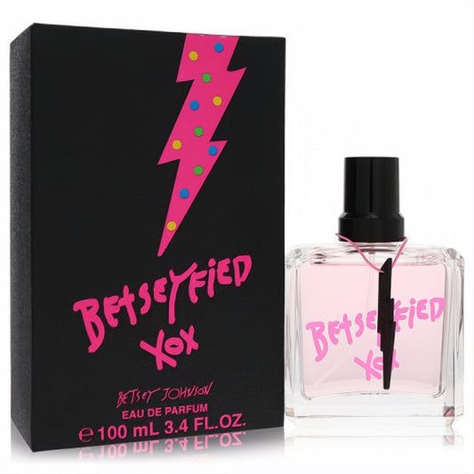 Vibrant Betsey Johnson Betseyfied 3.4 oz Eau De Parfum. Pink fragrance in clear bottle, beside a black box with a bold pink lightning bolt.