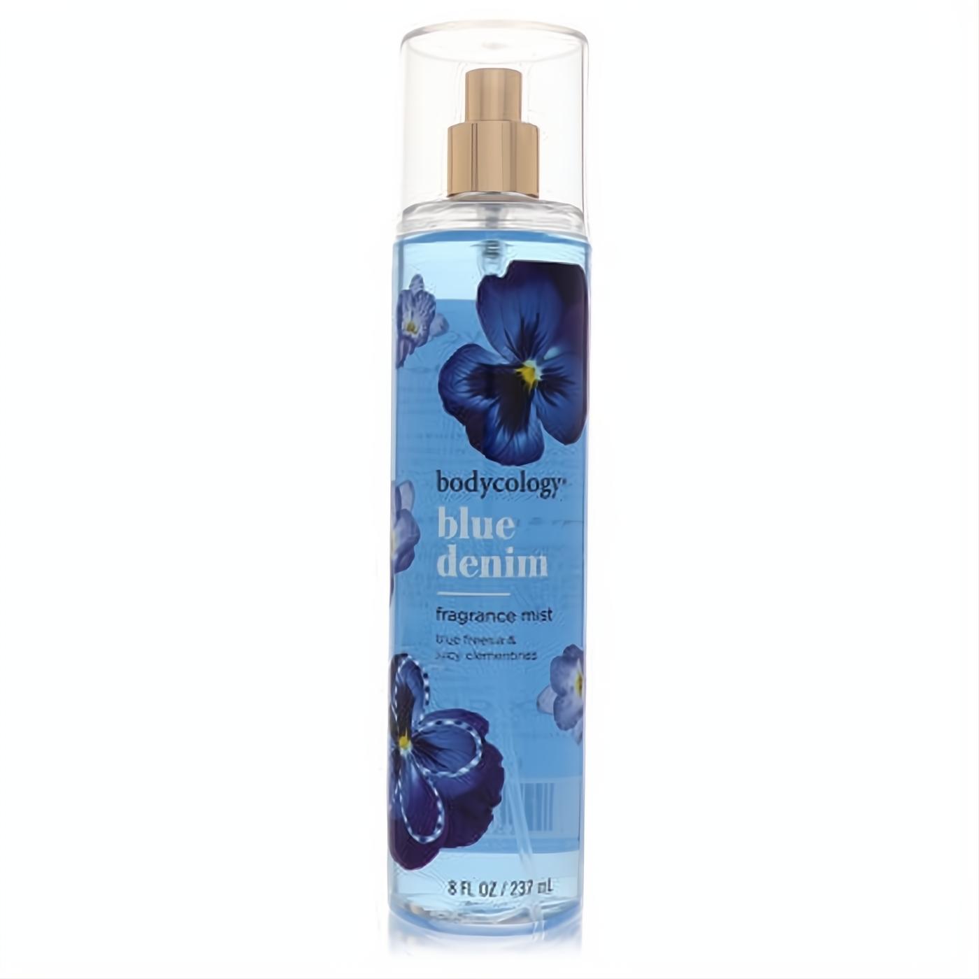 Invigorating Bodycology Blue Denim fragrance mist, 8 oz. Clear bottle, light blue liquid, gold sprayer, and elegant blue pansy floral label.
