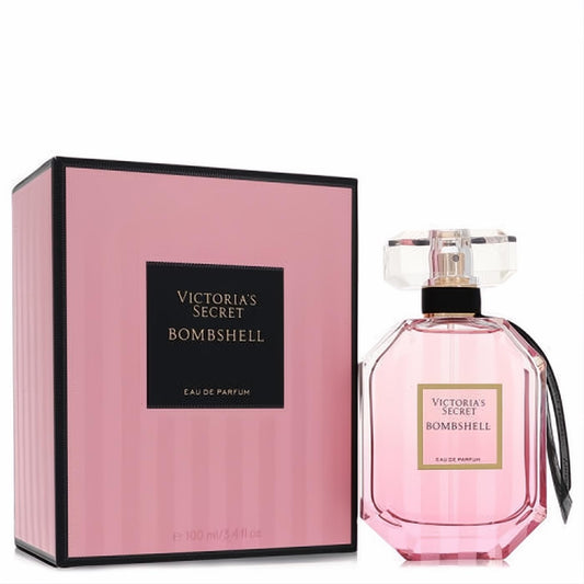 Victoria's Secret Bombshell 3.4 oz Eau De Parfum in a stunning pink bottle with faceted cap and elegant striped box.