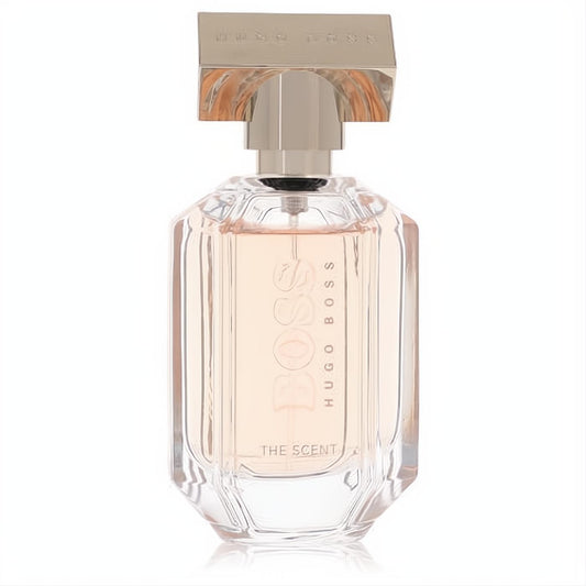 Sophisticated Boss The Scent 1.7 oz women's EDP. Faceted clear bottle with peach liquid, topped by a sleek rose gold cap.