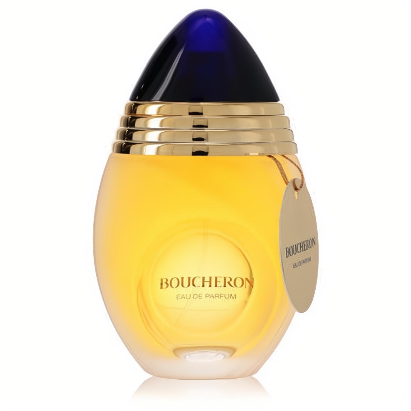 Elegant Boucheron Eau De Parfum spray in a frosted glass bottle with golden liquid, deep blue cap, and luxurious gold accents.