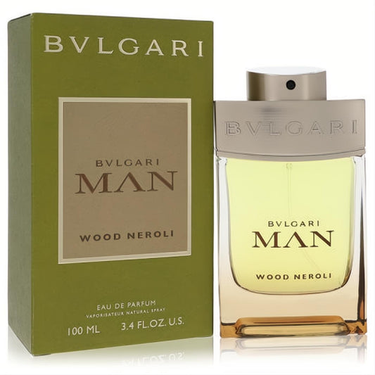 Bvlgari Man Wood Neroli 3.4 oz EDP. Elegant clear glass bottle with amber liquid, silver cap, and olive green box.