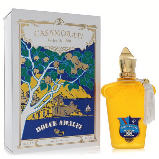 Casamorati Dolce Amalfi 3.4 oz perfume: vibrant yellow bottle, gold cap, white tassel, and ornate white illustrated box.