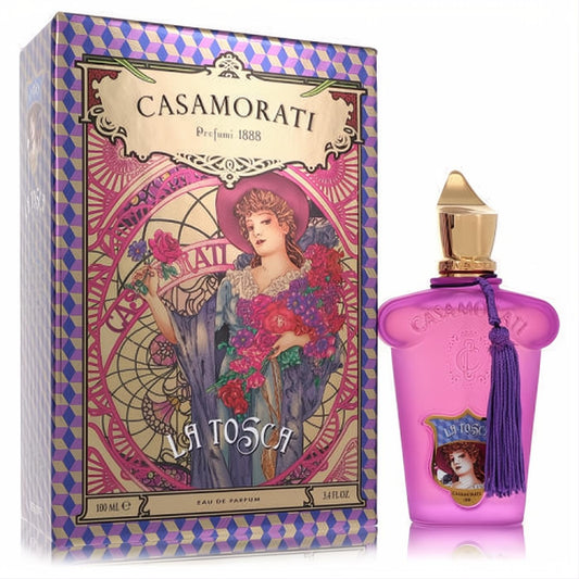 Luxurious pink frosted Casamorati La Tosca 3.4 oz perfume bottle with gold cap and purple tassel, beside its ornate purple and gold box.