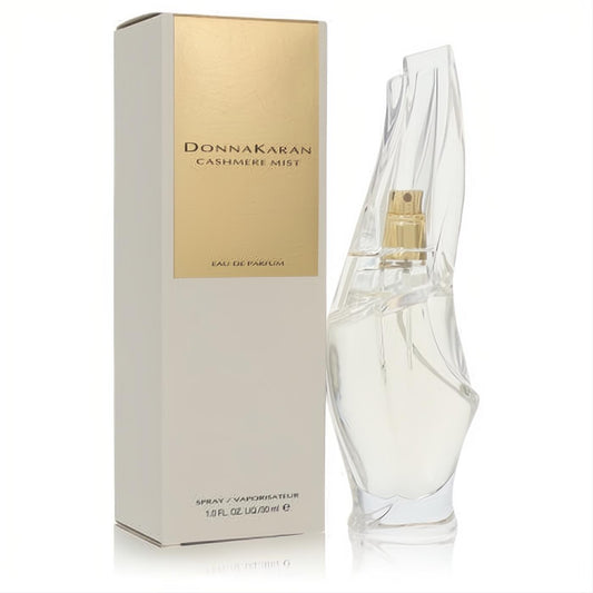 Donna Karan Cashmere Mist 1 oz Eau De Parfum spray. Elegant clear sculptural bottle with gold accents and a luxurious cream/gold box.