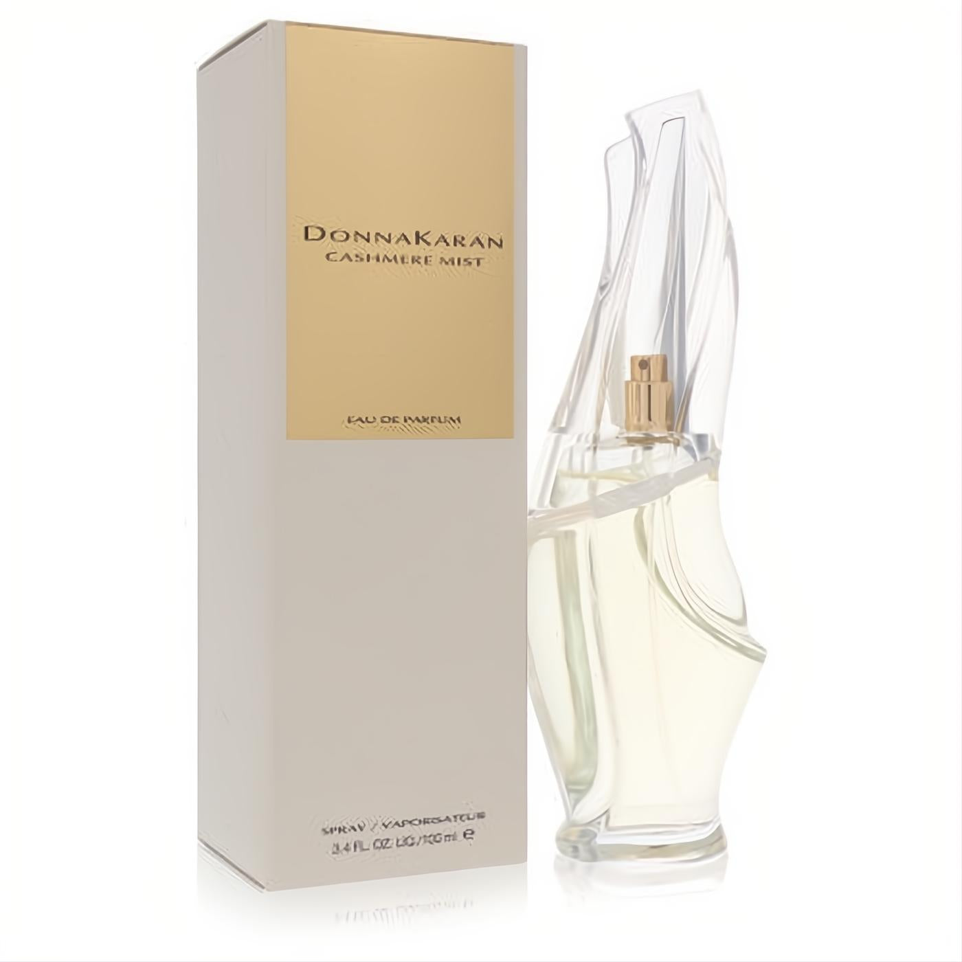 Donna Karan Cashmere Mist 3.4 oz EDP spray. Elegant clear sculptural bottle, gold nozzle, and luxurious beige & gold box.