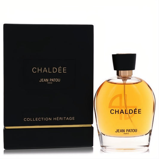 Luxurious Chaldee by Jean Patou 3.3 oz EDP in a stunning clear glass bottle with golden amber fragrance, next to its elegant black and gold box.