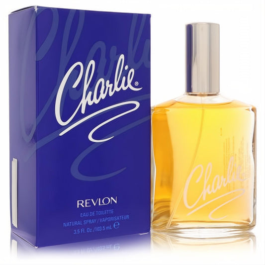 Charlie by Revlon 3.4 oz Eau De Toilette: golden liquid in a clear glass bottle with silver cap, beside its iconic royal blue box.