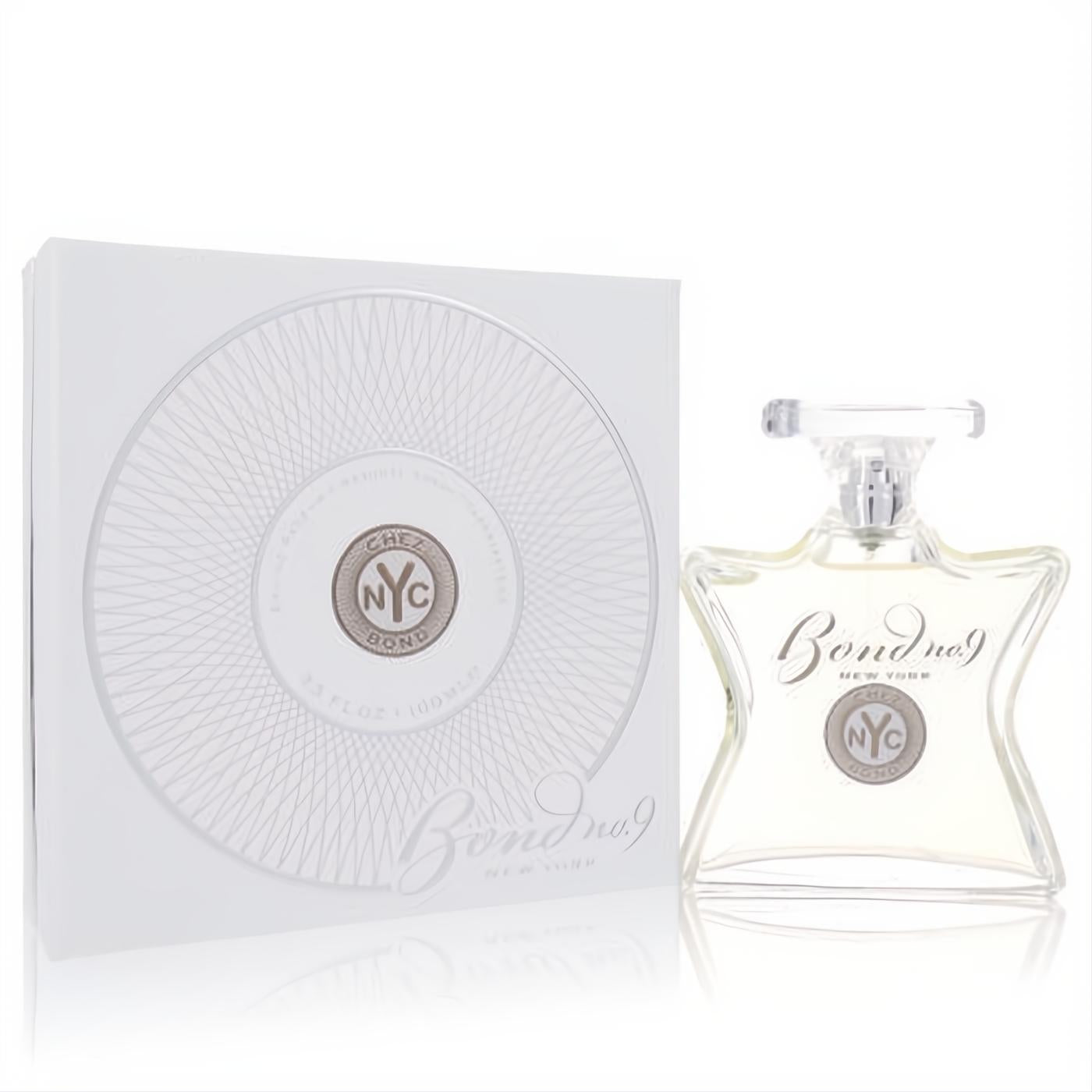 Bond No. 9 Chez Bond 3.3 oz men's EDP. Clear, elegant bottle with silver NYC emblem, beside its white and silver box.