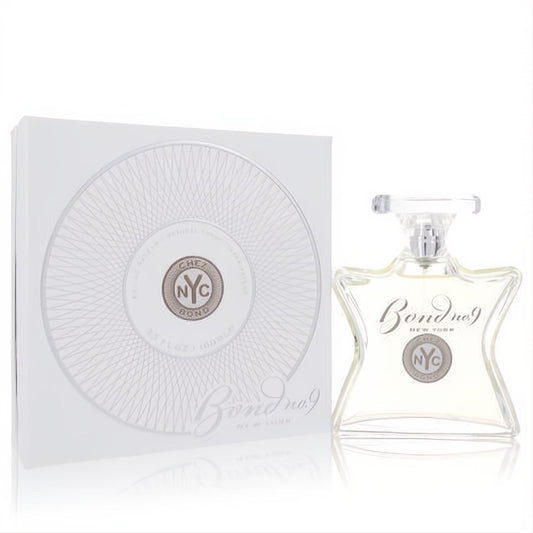 Bond No. 9 Chez Bond 3.3 oz men's EDP. Clear, elegant bottle with silver NYC emblem, beside its white and silver box.