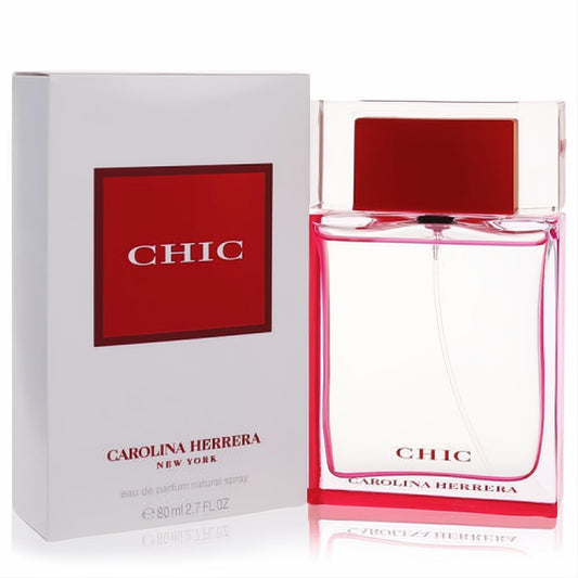 Chic by Carolina Herrera 2.7 oz EDP: clear glass bottle with vibrant red base and cap, beside its elegant white box.