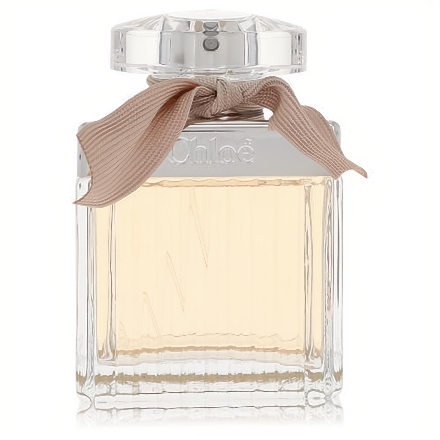 Chloe Eau De Parfum 2.5 oz spray in a clear glass bottle with amber liquid, featuring a delicate pink ribbon and faceted cap.