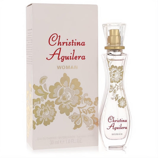 Christina Aguilera Woman 1 oz EDP spray: elegant clear curved bottle with luxurious gold floral details and matching white box.