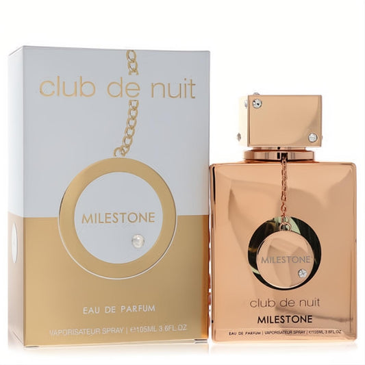 Luxurious Armaf Club De Nuit Milestone 3.6 oz rose gold perfume bottle with chain and crystal, beside its elegant white and gold box.