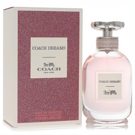Coach Dreams 2 oz EDP spray for women. Beautiful pink fragrance in a clear glass bottle with a silver floral cap, beside its textured pink box.