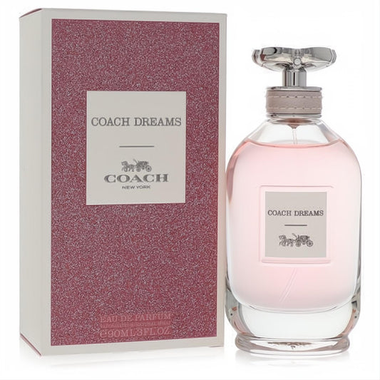 Elegant Coach Dreams 3 oz Eau De Parfum spray for women, with a clear pink bottle, silver floral cap, and matching textured box.