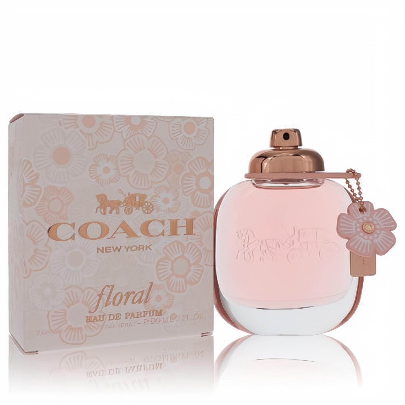 Dazzling Coach Floral Eau De Parfum 3 oz spray, with a soft pink bottle, rose gold cap, and delicate floral charm, beside its matching patterned box.