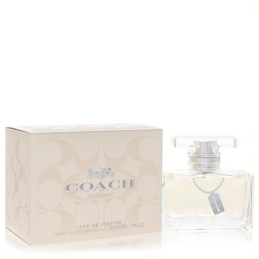Experience Coach Signature 1 oz Eau De Parfum: a sleek clear glass bottle with silver details, beside its elegant beige embossed logo box.