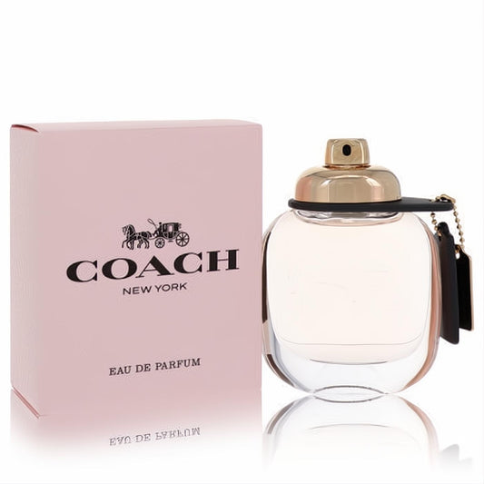 Elegant Coach Eau De Parfum 1.7 oz for women. Clear glass bottle, gold cap, black leather tag, and blush pink box.