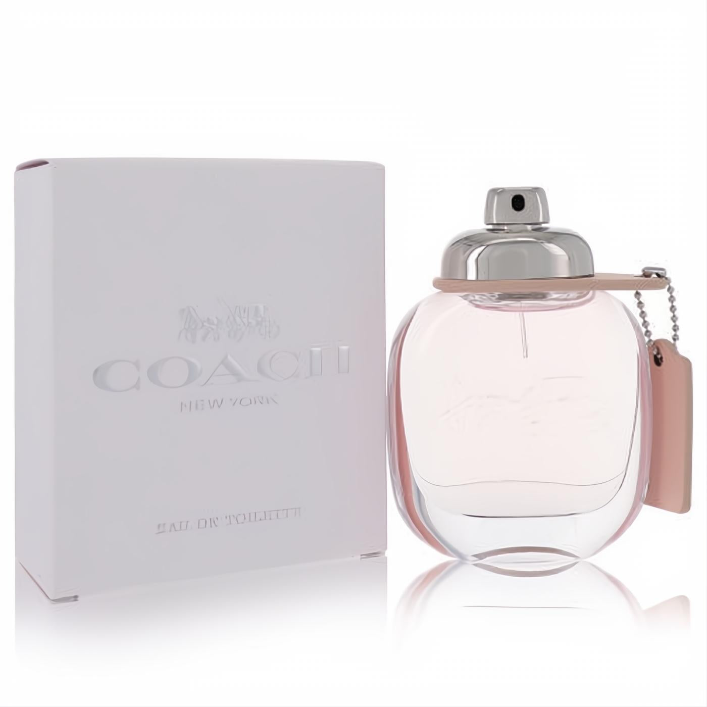 Coach Eau De Toilette 1.7 oz women's fragrance. Elegant clear bottle with light pink liquid, silver cap, and signature pink leather tag.