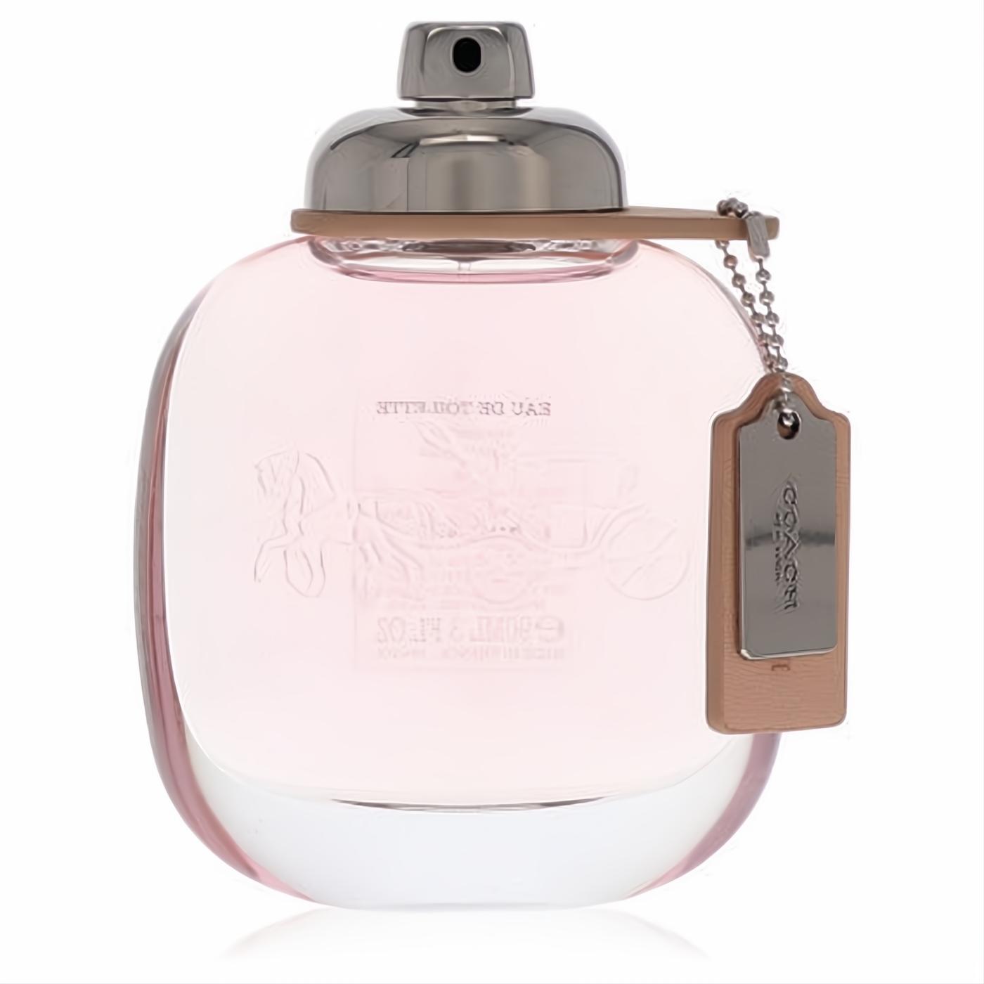 Elegant Coach Eau De Toilette 3 oz spray. Clear rounded bottle with soft pink liquid, silver cap, and signature leather tag.