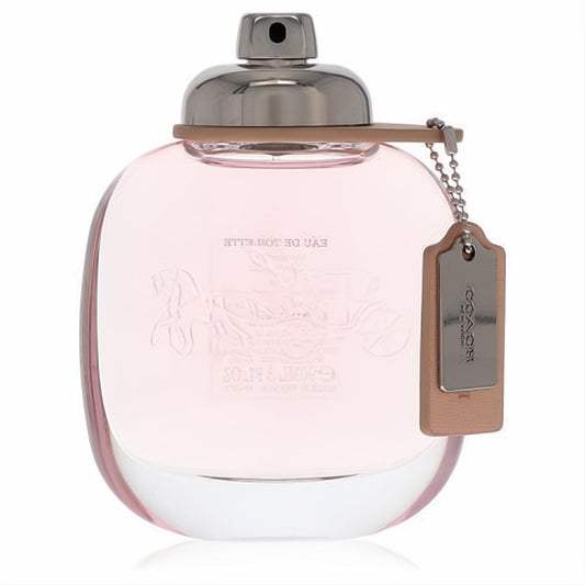 Elegant Coach Eau De Toilette 3 oz spray. Clear rounded bottle with soft pink liquid, silver cap, and signature leather tag.