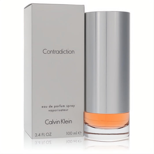 Calvin Klein Contradiction 3.4 oz Eau de Parfum Spray for women. Sleek silver and clear bottle with amber liquid, beside its elegant gray box.