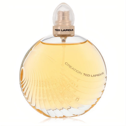 Creation Ted Lapidus 3.4 oz women's EDT spray. Luxurious round glass bottle with golden amber liquid, textured cap, and elegant swirling design.