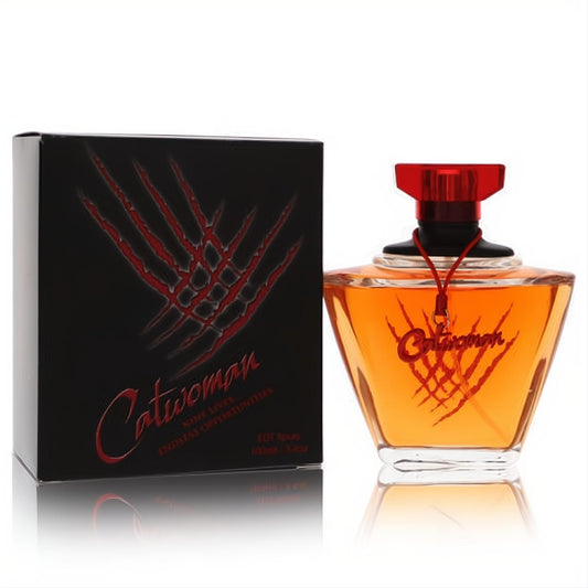 DC Comics Catwoman 3.4 oz EDT spray. Amber liquid in a sleek angular bottle with a red cap and iconic claw mark design.