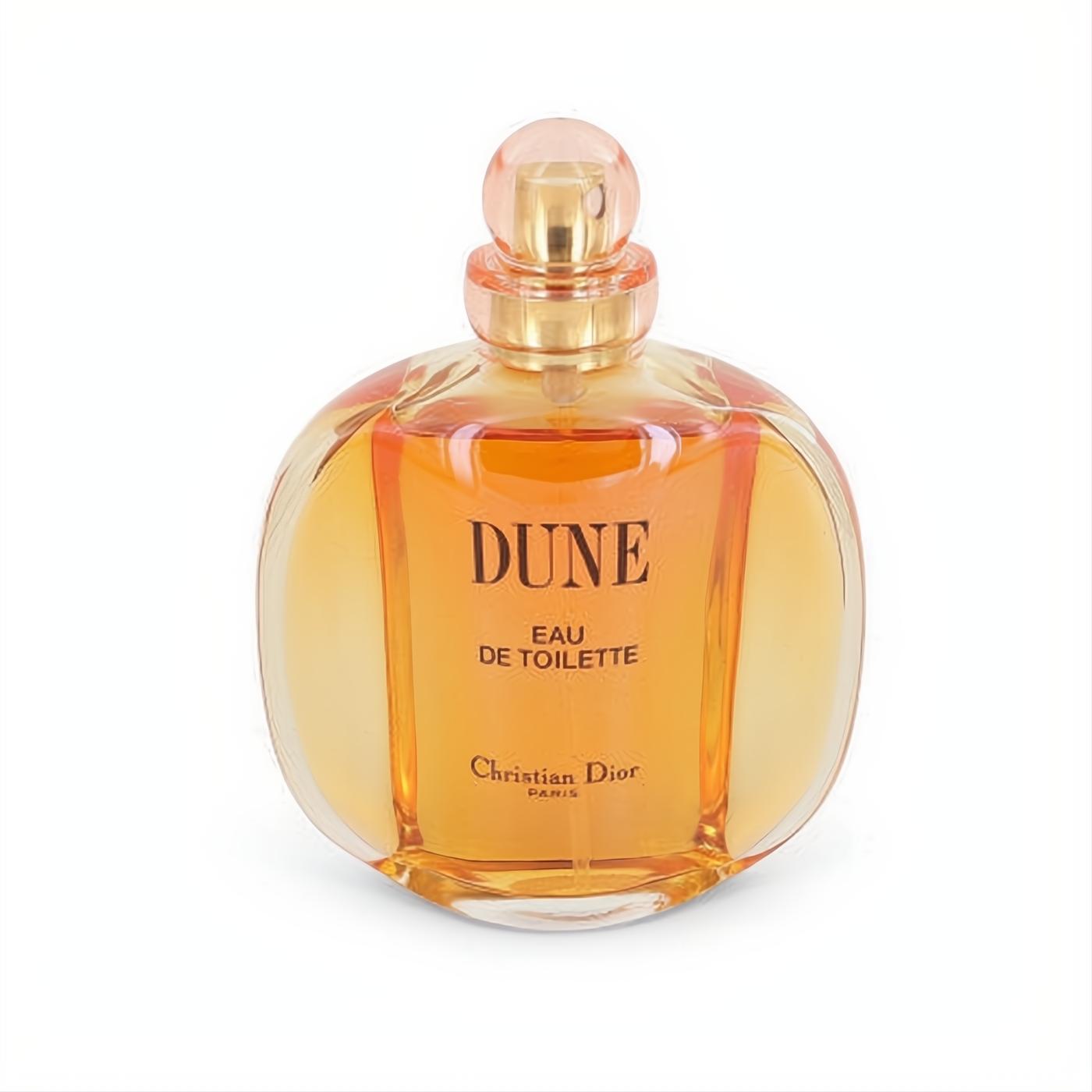Iconic Dune by Christian Dior Eau De Toilette 3.4 oz. Elegant clear glass bottle with warm amber fragrance and a sophisticated peachy cap.
