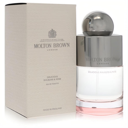 Molton Brown Delicious Rhubarb & Rose 3.3 oz Eau De Toilette. Elegant clear bottle with pink liquid, silver cap, and textured beige box.