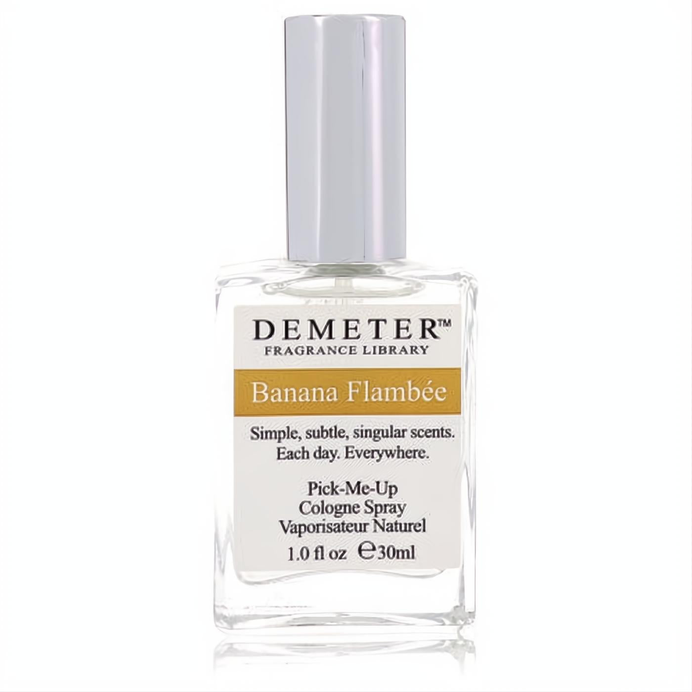Demeter Banana Flambee 1 oz women's cologne spray. Clear glass bottle, sleek silver cap, and a vibrant golden label.