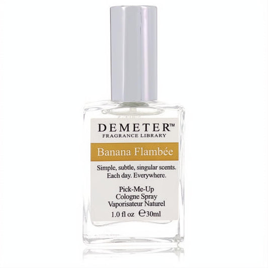 Demeter Banana Flambee 1 oz women's cologne spray. Clear glass bottle, sleek silver cap, and a vibrant golden label.