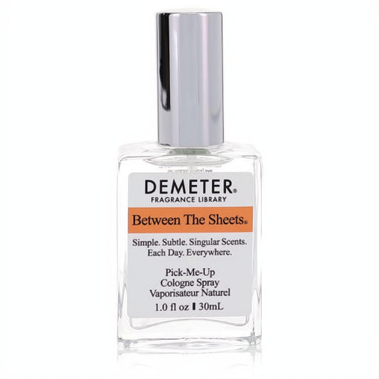 Demeter Between The Sheets 1 oz cologne spray. Elegant clear glass bottle, sleek silver cap, and vibrant orange-banded label.