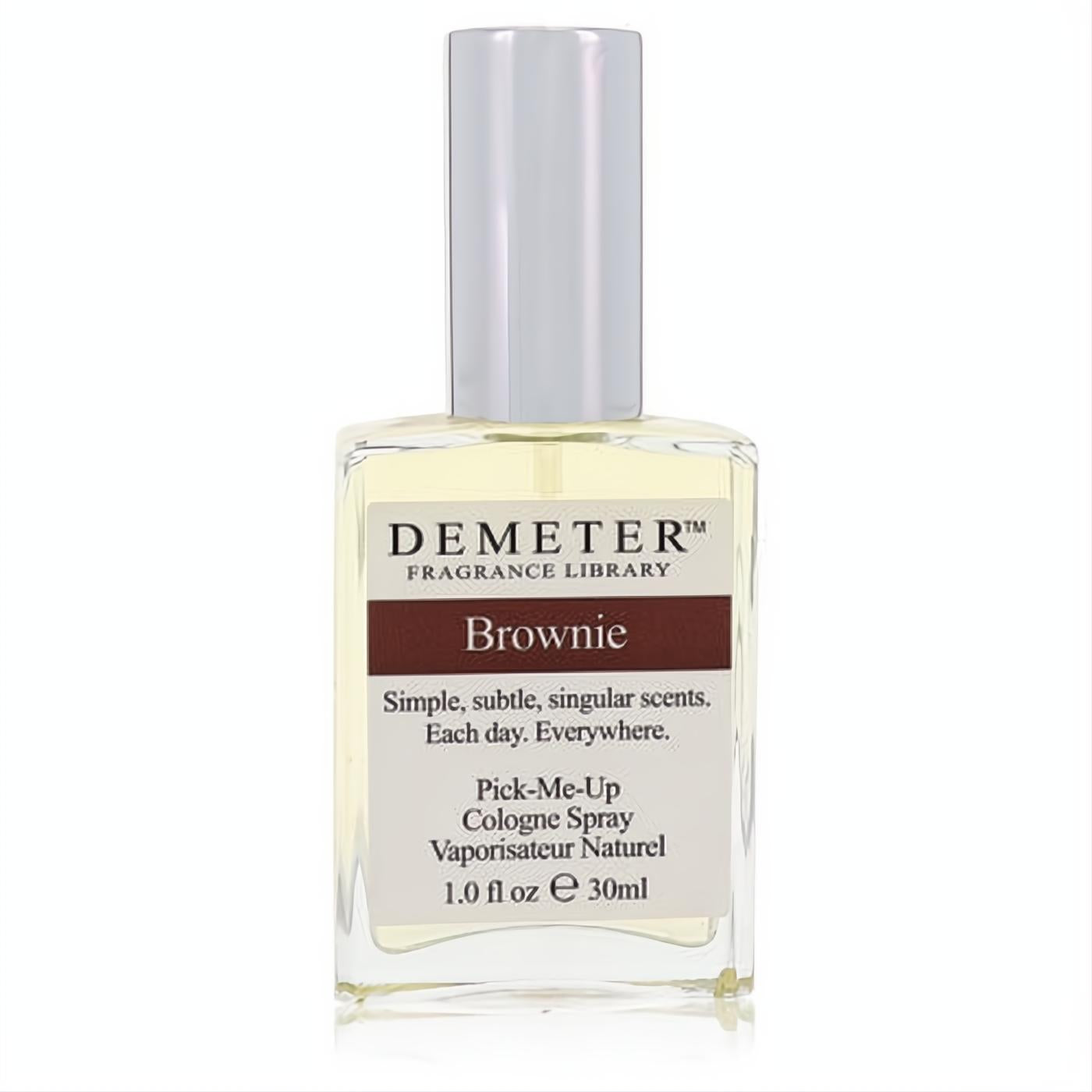 Indulge in Demeter Brownie 1 oz women's cologne spray. Clear glass bottle, sleek silver cap, rich brown label.