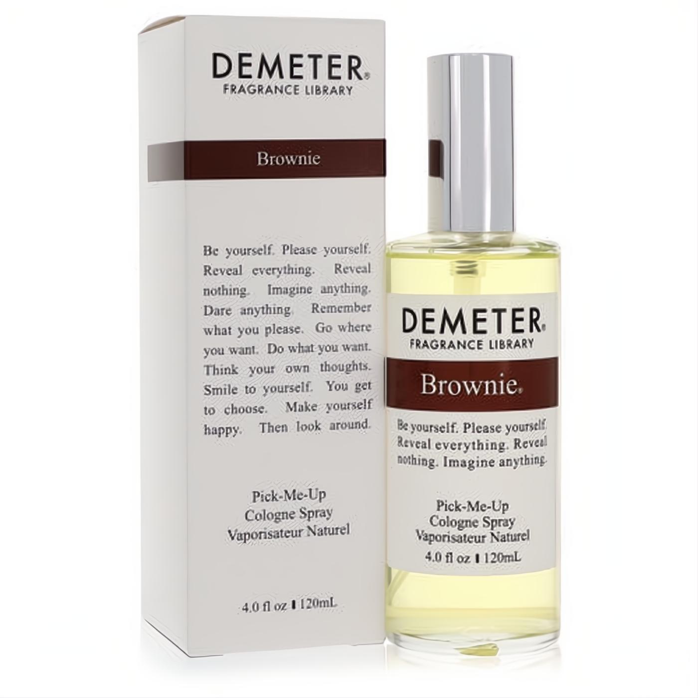 Experience Demeter Brownie 4 oz cologne spray. Clear glass bottle, silver cap, and stylish white box with brown accents.