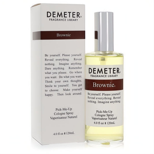 Experience Demeter Brownie 4 oz cologne spray. Clear glass bottle, silver cap, and stylish white box with brown accents.