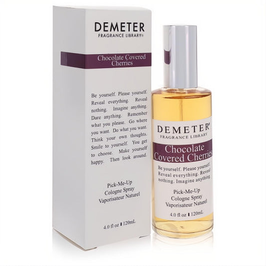 Demeter Chocolate Covered Cherries 4 oz cologne spray. Clear glass bottle with amber liquid, next to its sleek white box with purple accents.