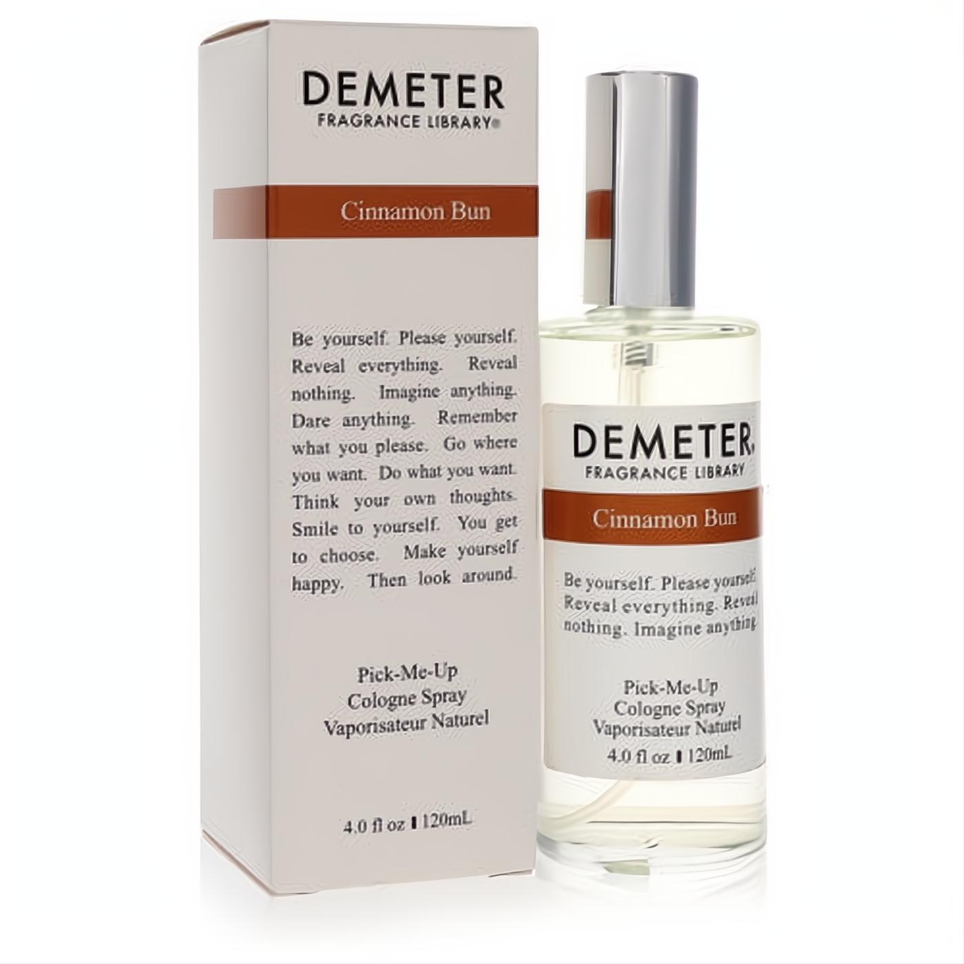 Indulge in Demeter Cinnamon Bun 4 oz cologne spray. Clear glass bottle, silver cap, and elegant white box with brown branding.