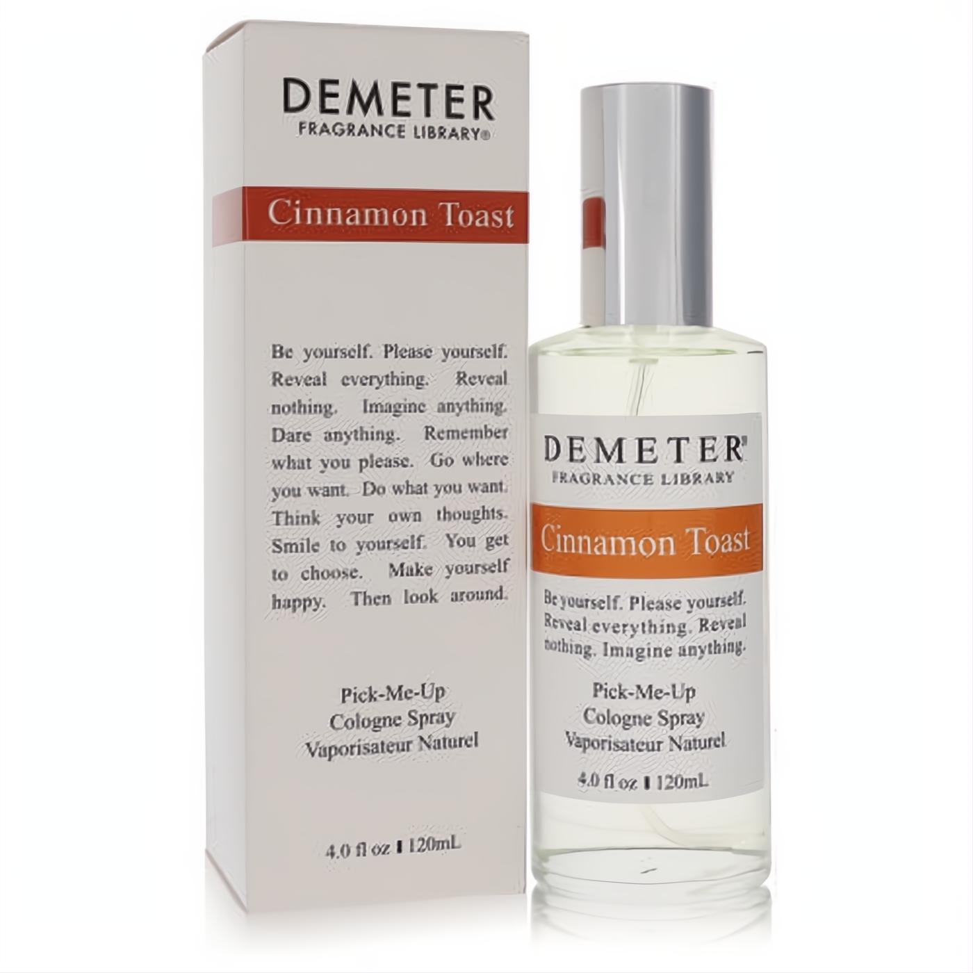 Demeter Cinnamon Toast 4 oz cologne spray, clear glass bottle with silver cap, alongside its elegant white and orange-brown branded box.