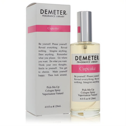 Demeter Cupcake 4 oz cologne spray fragrance. Clear glass bottle, sleek silver cap, and white box with a prominent pink "Cupcake" label.