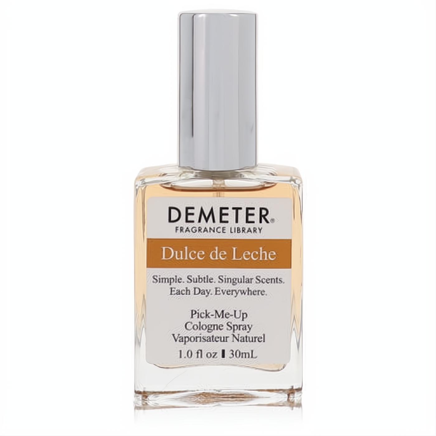 Demeter Dulce De Leche 1 oz cologne spray. Clear rectangular glass bottle with a silver cap and warm caramel-colored liquid.